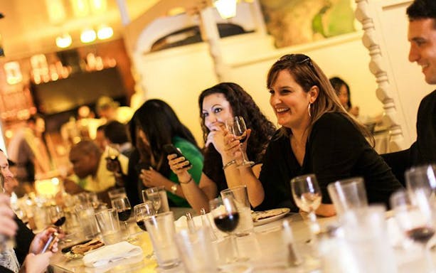 Group enjoying wine and conversation on North Beach Food Tour.