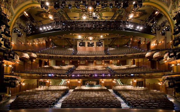 New Amsterdam Theatre interior with ornate balconies and stage view, part of Disney on Broadway tour.