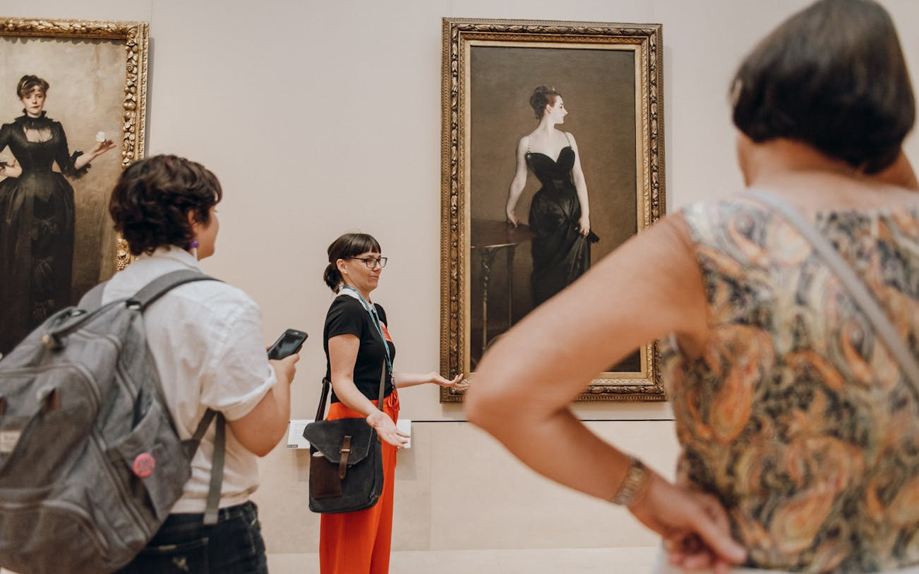 Tour guide discussing paintings at the Metropolitan Museum of Art.