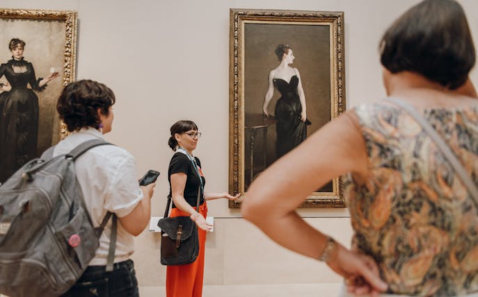 Tour guide discussing paintings at the Metropolitan Museum of Art.