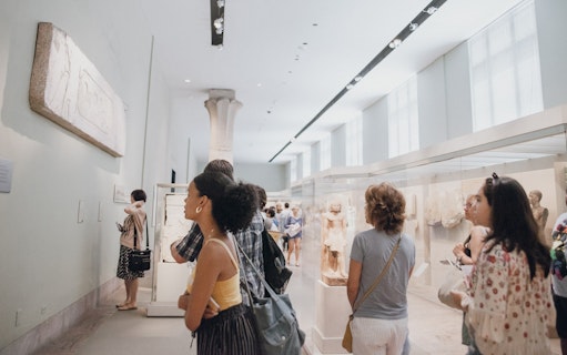 Visitors exploring sculptures at the Metropolitan Museum of Art, New York City.