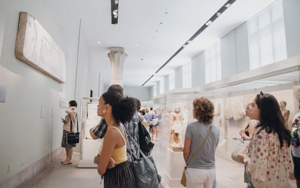 Visitors exploring sculptures at the Metropolitan Museum of Art, New York City.