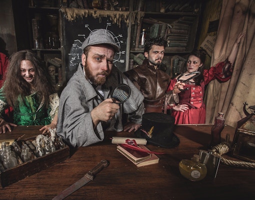 Actors in period costumes performing a scene at Edinburgh Dungeon.