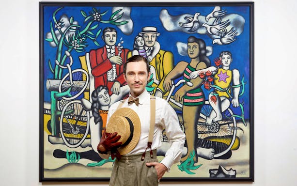 Man in vintage attire in front of Fernand Léger painting at Orsay Museum, Paris.
