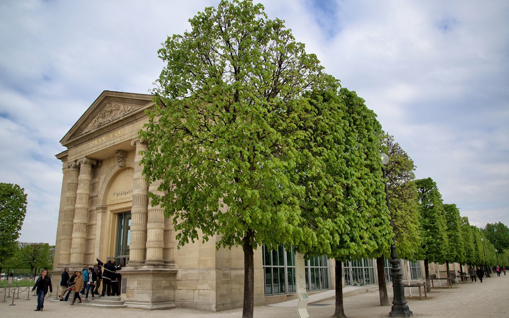 Entrance to The Orangerie Museum in Paris with visitors outside.