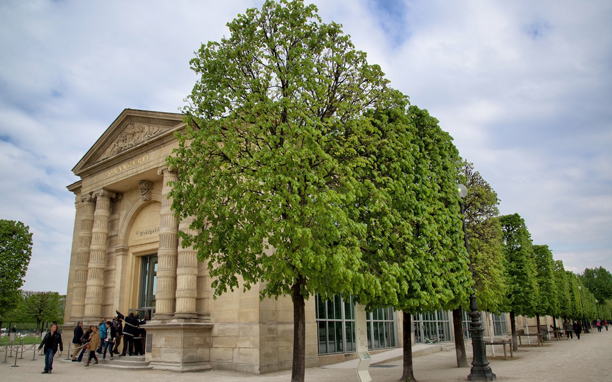 Entrance to The Orangerie Museum in Paris with visitors outside.