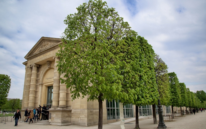 Entrance to The Orangerie Museum in Paris with visitors outside.