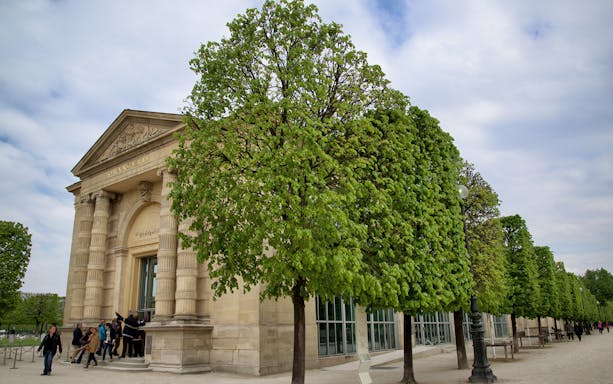 Entrance to The Orangerie Museum in Paris with visitors outside.