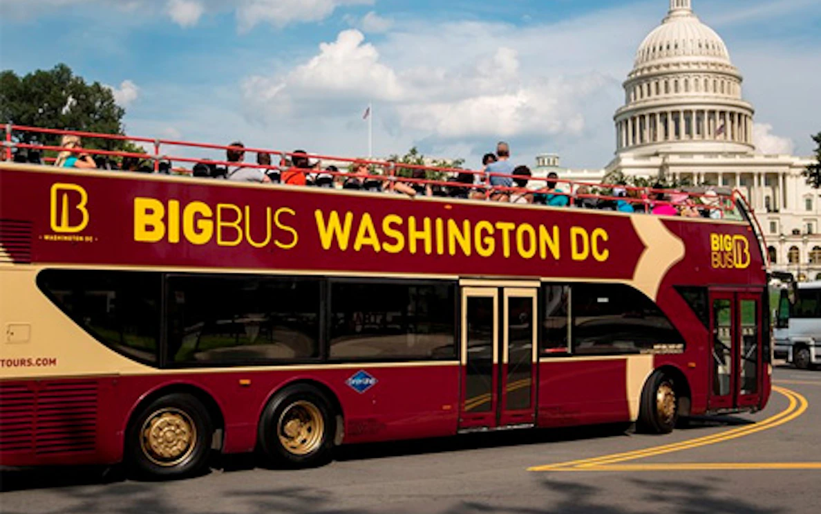 Hop on Hop off Big Bus passing by the US Capitol in Washington DC.