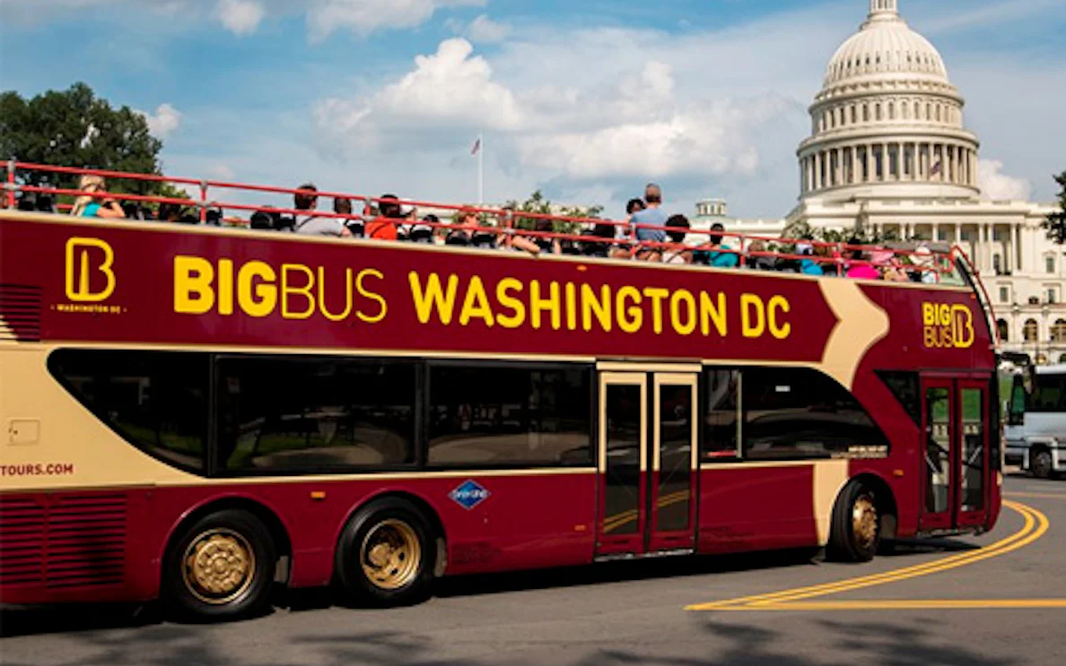 Hop on Hop off Big Bus passing by the US Capitol in Washington DC.