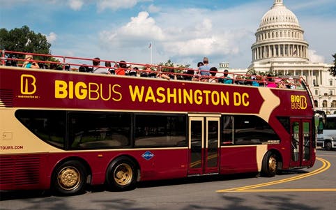 Hop on Hop off Big Bus passing by the US Capitol in Washington DC.