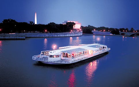 Dinner cruise boat on the Potomac River with Washington Monument in the background.