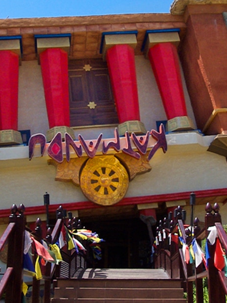 Katmandu Park entrance with lion statues and colorful flags, Mallorca.