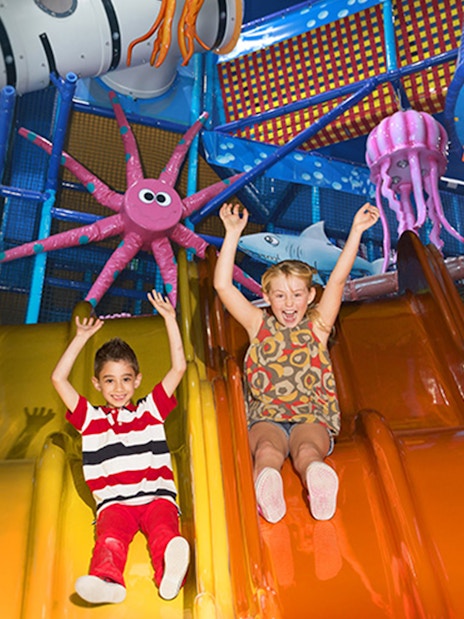 Children sliding in colorful play area at Katmandu Park.
