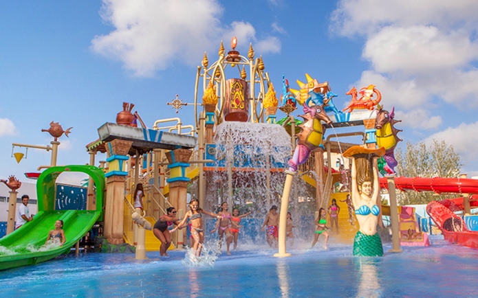 Children playing at the water park in Katmandu Park, featuring slides and colorful structures.