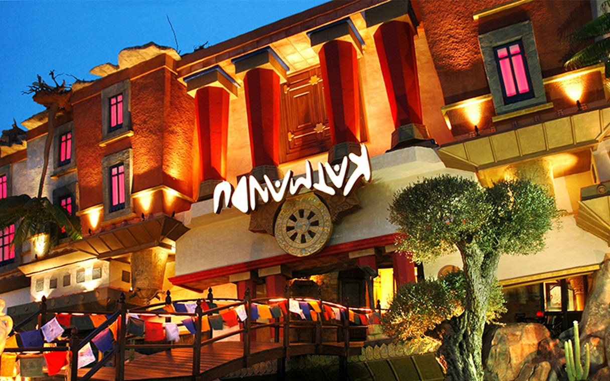 Katmandu Park entrance with vibrant lights and colorful flags in Mallorca.