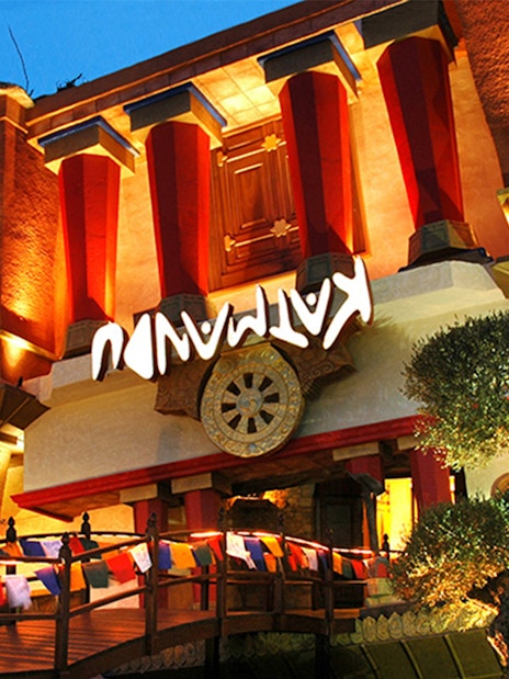Katmandu Park entrance with vibrant lights and colorful flags in Mallorca.