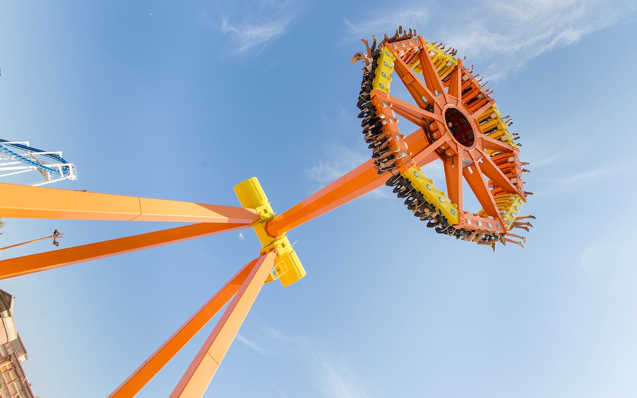 Visitors on a spinning ride at Terra Mitica theme park, Spain.