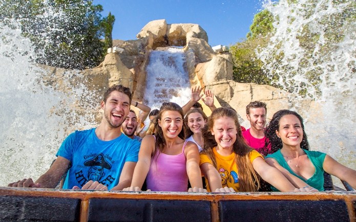 Visitors enjoying a water ride at Terra Mitica theme park.