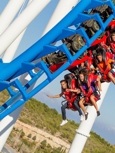 Roller coaster ride at Terra Mitica with passengers in mid-air.