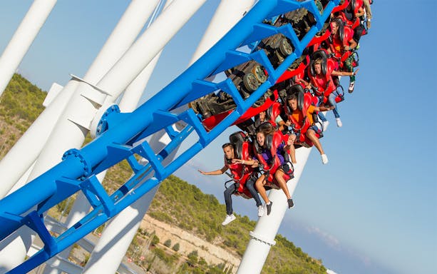 Roller coaster ride at Terra Mitica with passengers in mid-air.