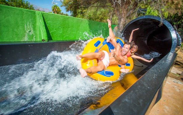 People enjoying a water slide at Aqualandia Benidorm.