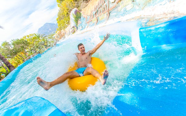 Person enjoying a water slide at Aqualandia Benidorm.