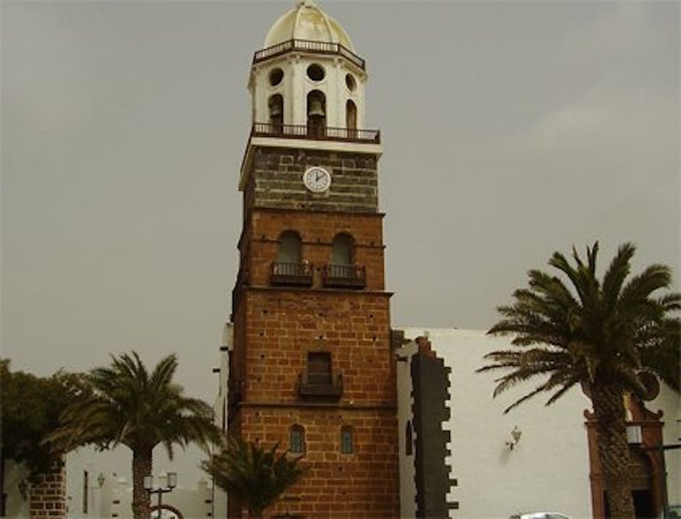 Teguise Street Market clock tower with palm trees, Lanzarote.