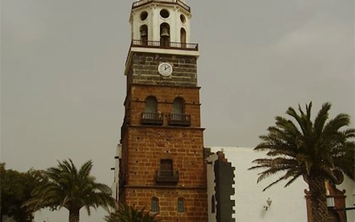 Teguise Street Market clock tower with palm trees, Lanzarote.