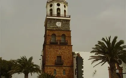 Teguise Street Market clock tower with palm trees, Lanzarote.