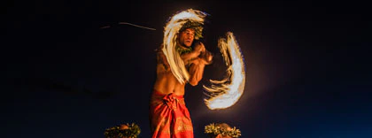 Performers on stage at Rock-A-Hula Show in Honolulu, Hawaii, showcasing vibrant Hawaiian dance and music.