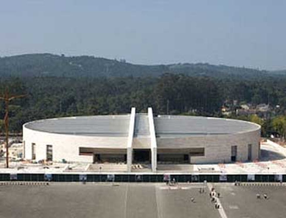 Fatima pilgrimage site with visitors exploring the sanctuary grounds, Portugal.