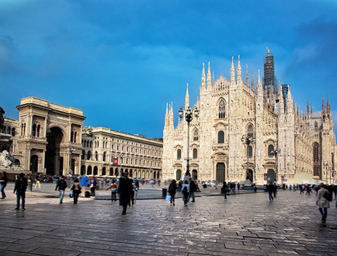 Milan's Duomo Cathedral with tourists in the square, part of a day trip from Lake Garda.