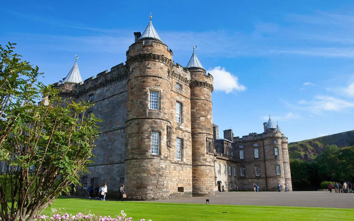 Palace of Holyroodhouse with visitors in Edinburgh's Old Town.