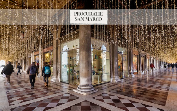 Procuratie San Marco arcade with lights, Venice Museums Pass tour.