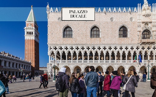 Doge's Palace in Venice with tourists in the foreground.