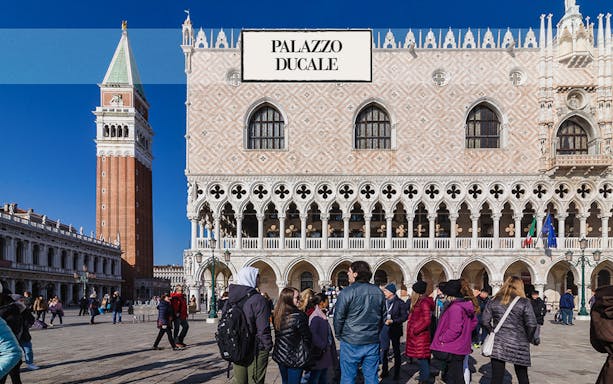Doge's Palace in Venice with tourists in the foreground.