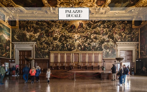 Palazzo Ducale interior with visitors viewing ornate artwork, Venice Museums Pass.