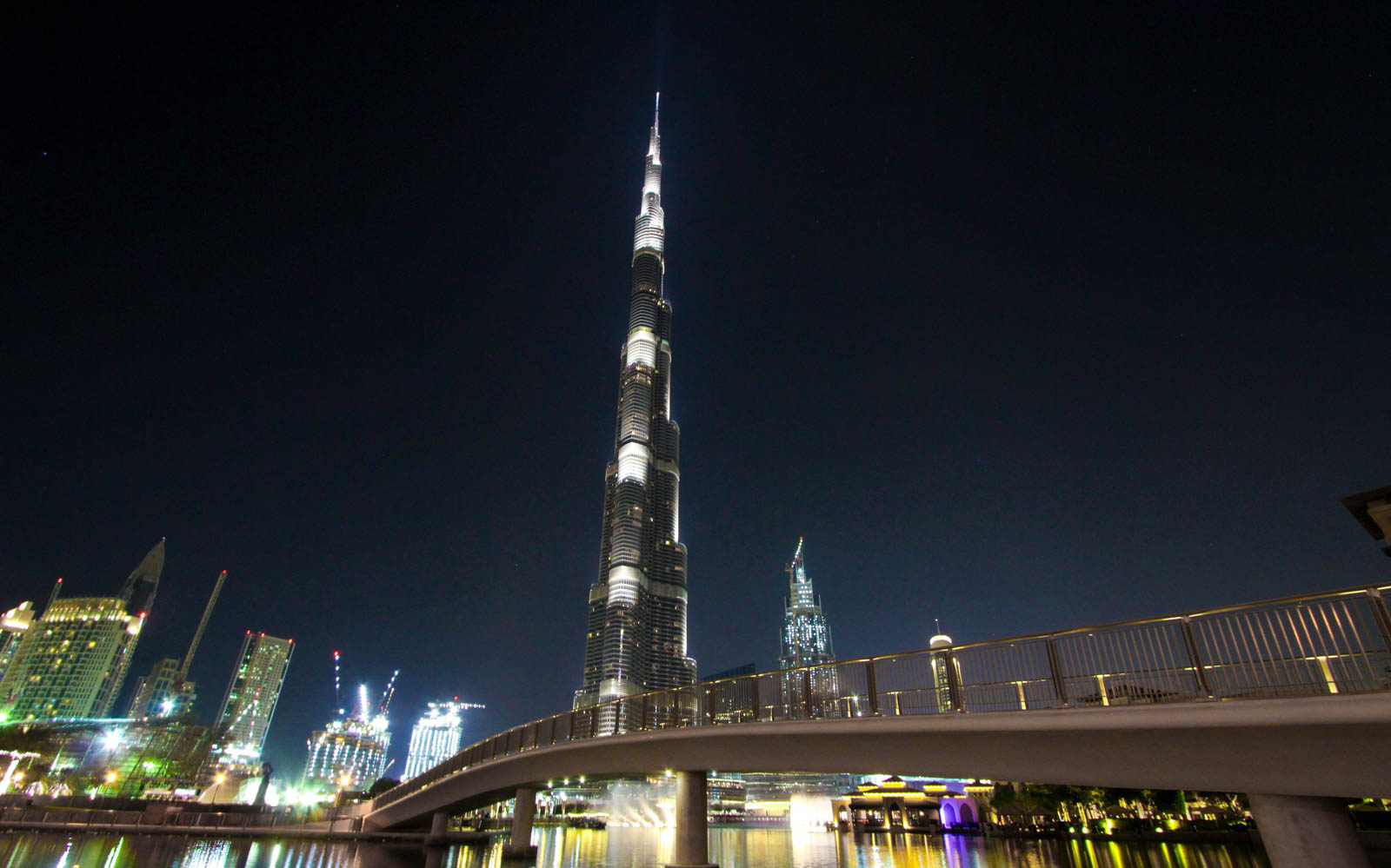 Burj Khalifa at night with Dubai Fountain Boardwalk in foreground.