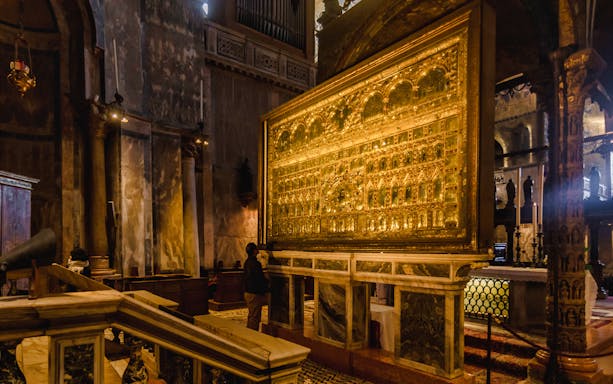Golden altar inside St. Mark's Basilica, Venice, during a walking tour.
