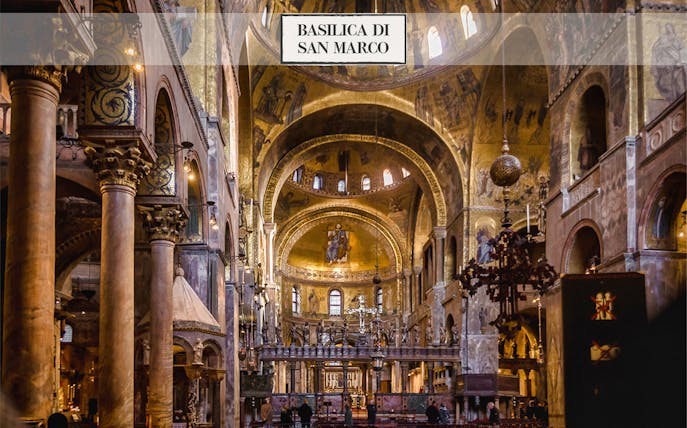 Interior of St. Mark's Basilica in Venice, showcasing ornate arches and golden mosaics.