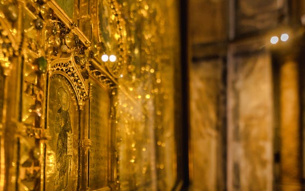 Golden mosaics inside St. Mark's Basilica, Venice, highlighting intricate religious artwork.