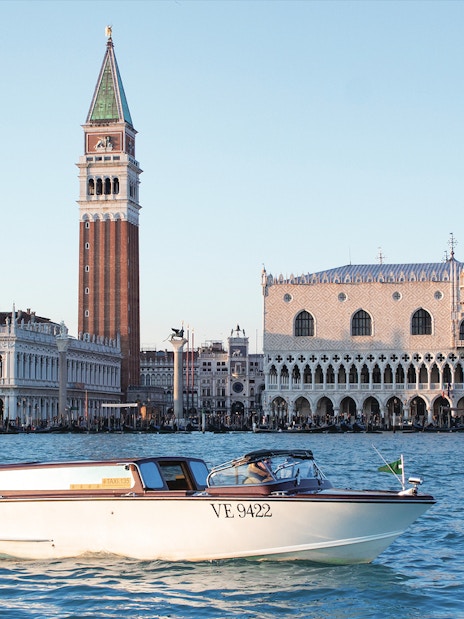 Water taxi on Grand Canal with Doge's Palace and Campanile in Venice.