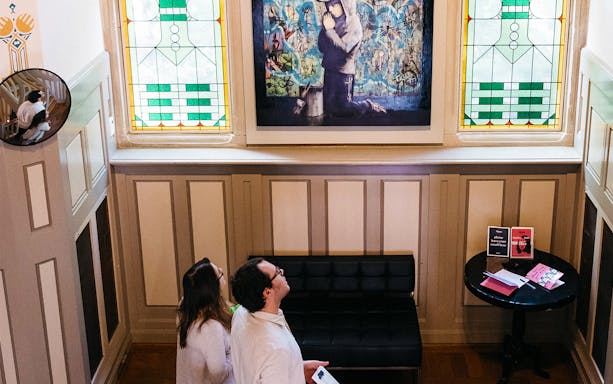 Visitors admiring artwork at Moco Museum, Amsterdam.