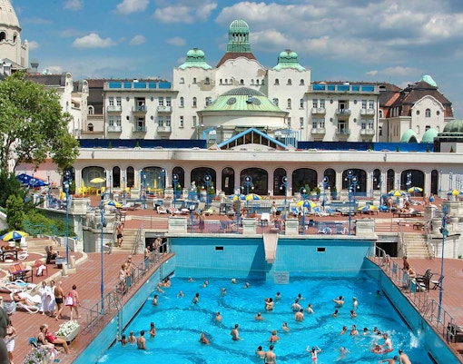 Gellért Spa thermal baths interior, Budapest, with visitors enjoying the pool.