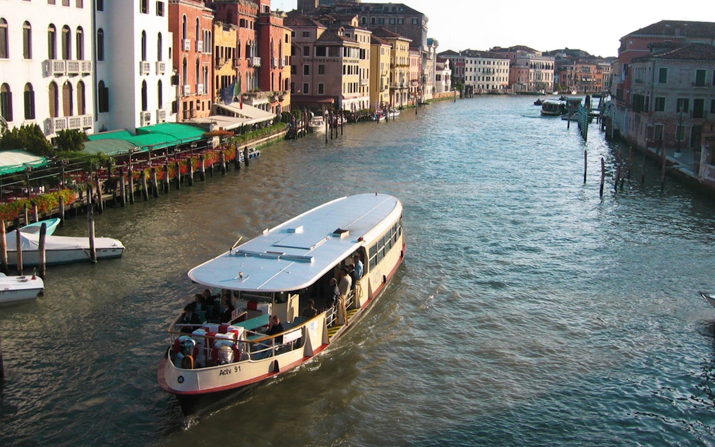 Venice ACTV water bus navigating the Grand Canal with historic buildings in view.