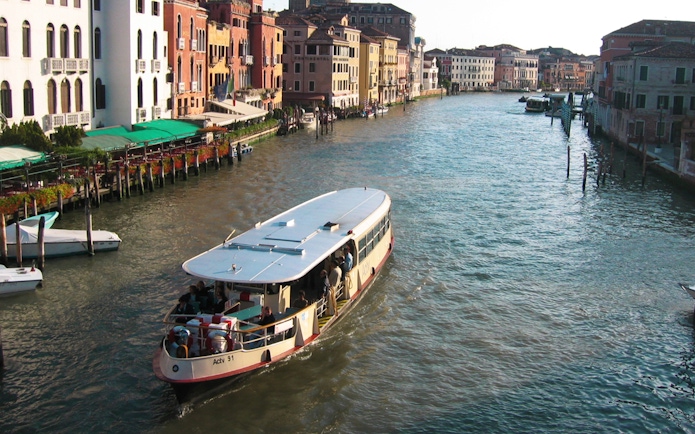 Venice ACTV water bus navigating the Grand Canal with historic buildings in view.