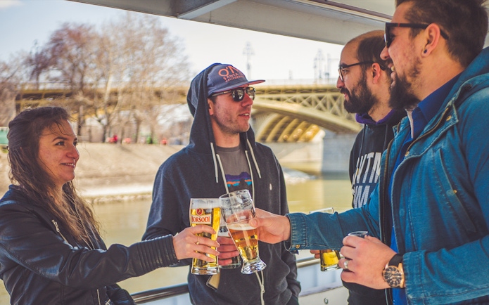 Group enjoying drinks on a Danube sightseeing cruise in Budapest.