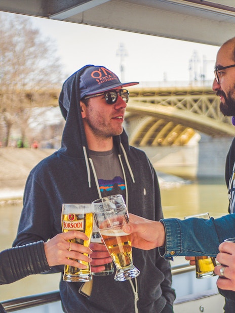 Group enjoying drinks on a Danube sightseeing cruise in Budapest.