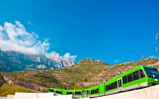 Train ascending Montserrat mountain with scenic view, part of TotMontserrat Card tour from Barcelona.